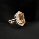 An authentic natural color-change faceted emerald-cut rectangular zultanite gemstone 925 sterling silver double halo ring.