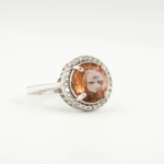 An authentic natural color-change faceted round-cut zultanite gemstone 925 sterling silver halo ring.