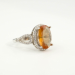 An authentic natural color-change faceted oval zultanite gemstone 925 sterling silver split shank halo ring.