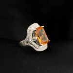 An authentic natural color-change faceted emerald-cut rectangular zultanite gemstone 925 sterling silver wide pave band ring.