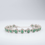 An authentic natural faceted oval green emerald gemstone 925 sterling silver luxury halo tennis bracelet.
