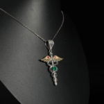 An authentic natural emerald, ruby and fancy yellow diamond Caduceus medical symbol 925 sterling silver pendant.