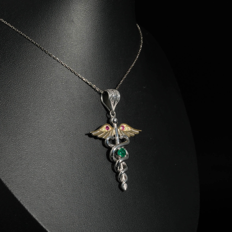 An authentic natural emerald, ruby and fancy yellow diamond Caduceus medical symbol 925 sterling silver pendant.