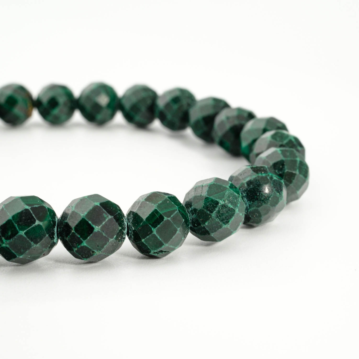 An authentic 8mm natural faceted green banded malachite gemstone beaded stretch bracelet.