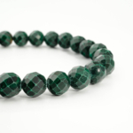 An authentic 8mm natural faceted green banded malachite gemstone beaded stretch bracelet.