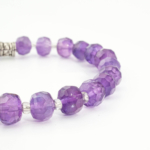 An authentic 6x8mm natural purple faceted rondelle amethyst gemstone beaded stretch bracelet.