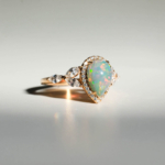 An authentic natural colorful pear cabochon opal gemstone rose gold plated 925 silver ring with marquise side stones.