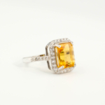 An authentic natural golden yellow faceted emerald-cut citrine gemstone 925 sterling silver halo ring with pave cz stones.