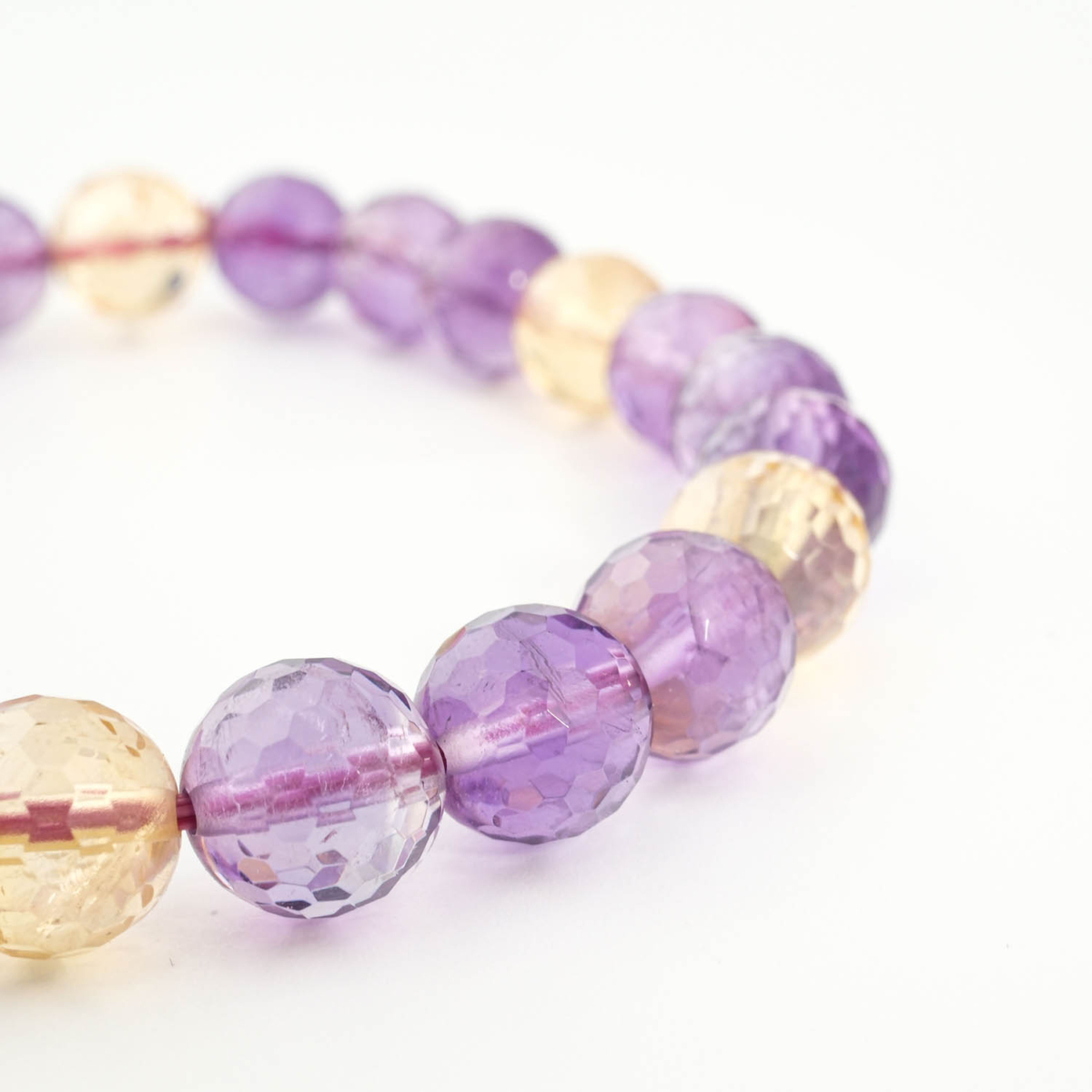 An authentic premium 6A+ grade natural purple and yellow faceted ametrine gemstone beaded stretch bracelet.