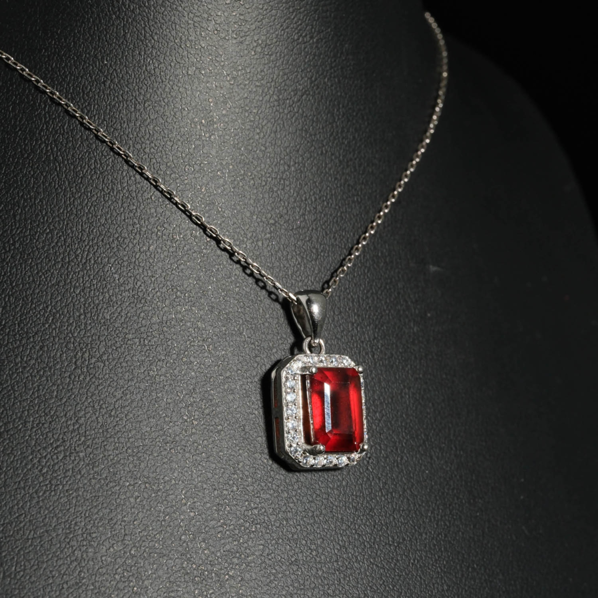 An authentic natural baguette cut red hessonite garnet gemstone 925 silver halo pendant necklace.