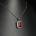 An authentic natural baguette cut red hessonite garnet gemstone 925 silver halo pendant necklace.