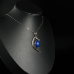 An authentic natural oval cabochon royal blue lapis lazuli gemstone crescent eye design 925 sterling silver pendant necklace.