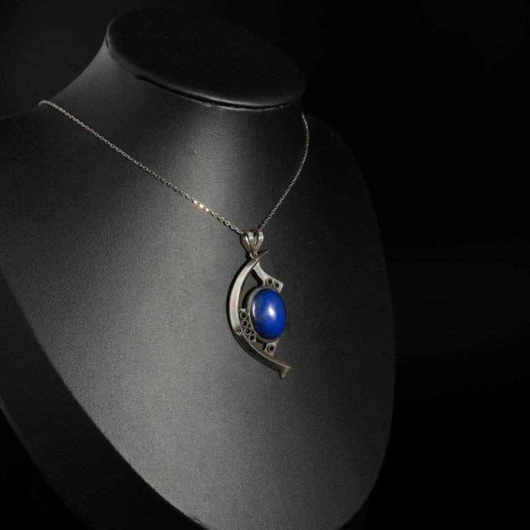 An authentic natural oval cabochon royal blue lapis lazuli gemstone crescent eye design 925 sterling silver pendant necklace.