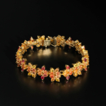 An authentic multi-color fancy yellow orange and pink natural sapphire gemstone flower design gold plated 925 silver bracelet.