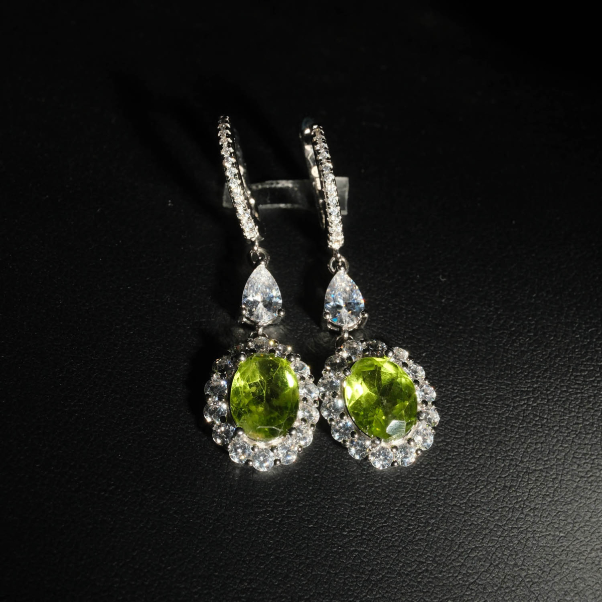 An authentic natural 3.67ct faceted oval green peridot gemstone 925 sterling silver drop halo dangle earrings.