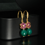 A luxurious pair of gold-plated 925 sterling silver dangle earrings featuring pink tourmaline flowers and faceted green agate beads.