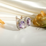 An authentic natural faceted oval purple amethyst gemstone 925 sterling silver halo earrings.