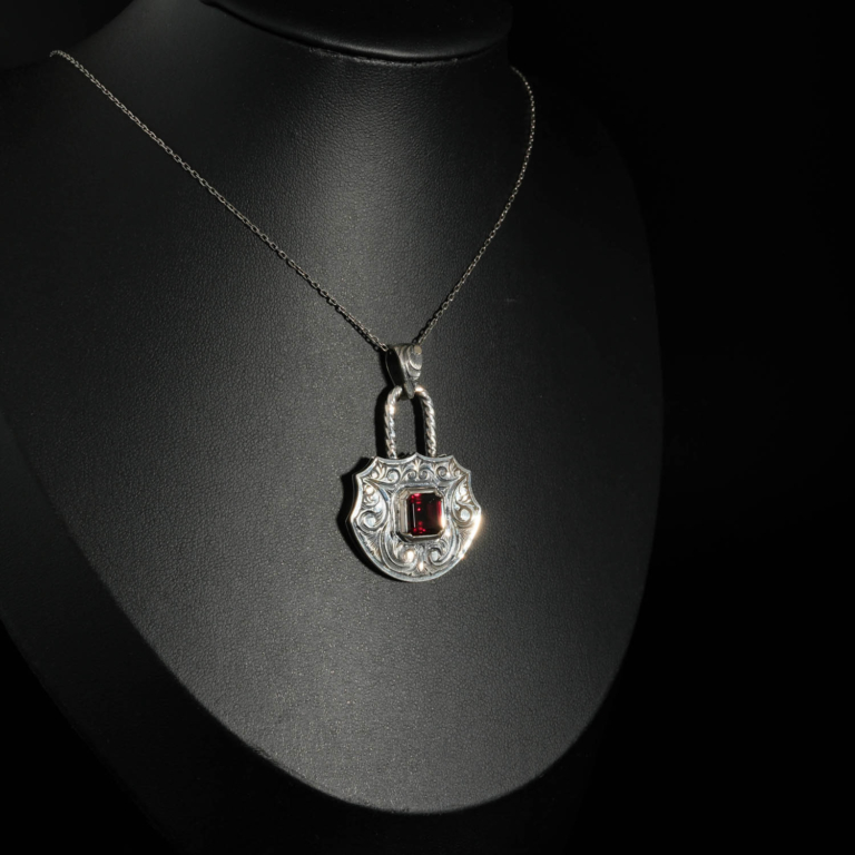 An authentic natural baguette cut red garnet gemstone padlock design engraved 925 sterling silver pendant necklace.