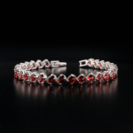 An authentic natural red garnet gemstone slanted oval faceted link 925 sterling silver tennis bracelet.