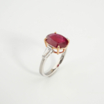 An authentic 4.66ct natural oval faceted red ruby gemstone 925 sterling silver two-tone ring with side baguettes.