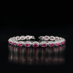 An authentic natural red ruby gemstone oval faceted zircon halo 925 sterling silver tennis bracelet.