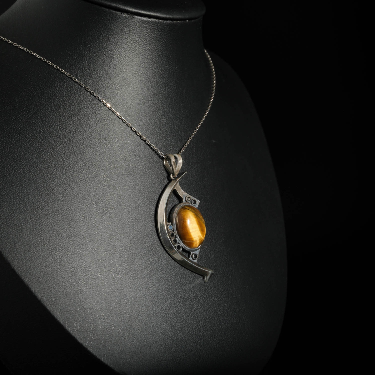 An authentic 14ct natural oval cabochon tiger eye gemstone crescent eye design 925 sterling silver pendant necklace.