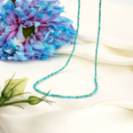 An authentic 2mm natural turquoise micro round gemstone beads necklace with stainless steel clasp.