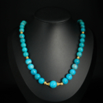 A luxurious 51+5cm graduated natural turquoise necklace featuring 8-12mm beads and gold-plated 925 silver accents.