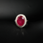 A 12.5 ct natural oval ruby gemstone ring crafted in 925 sterling silver with sparkling zircon halo accents.