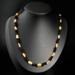 Certified natural amber adult necklace with yellow olive and cognac disc beads on white silk.
