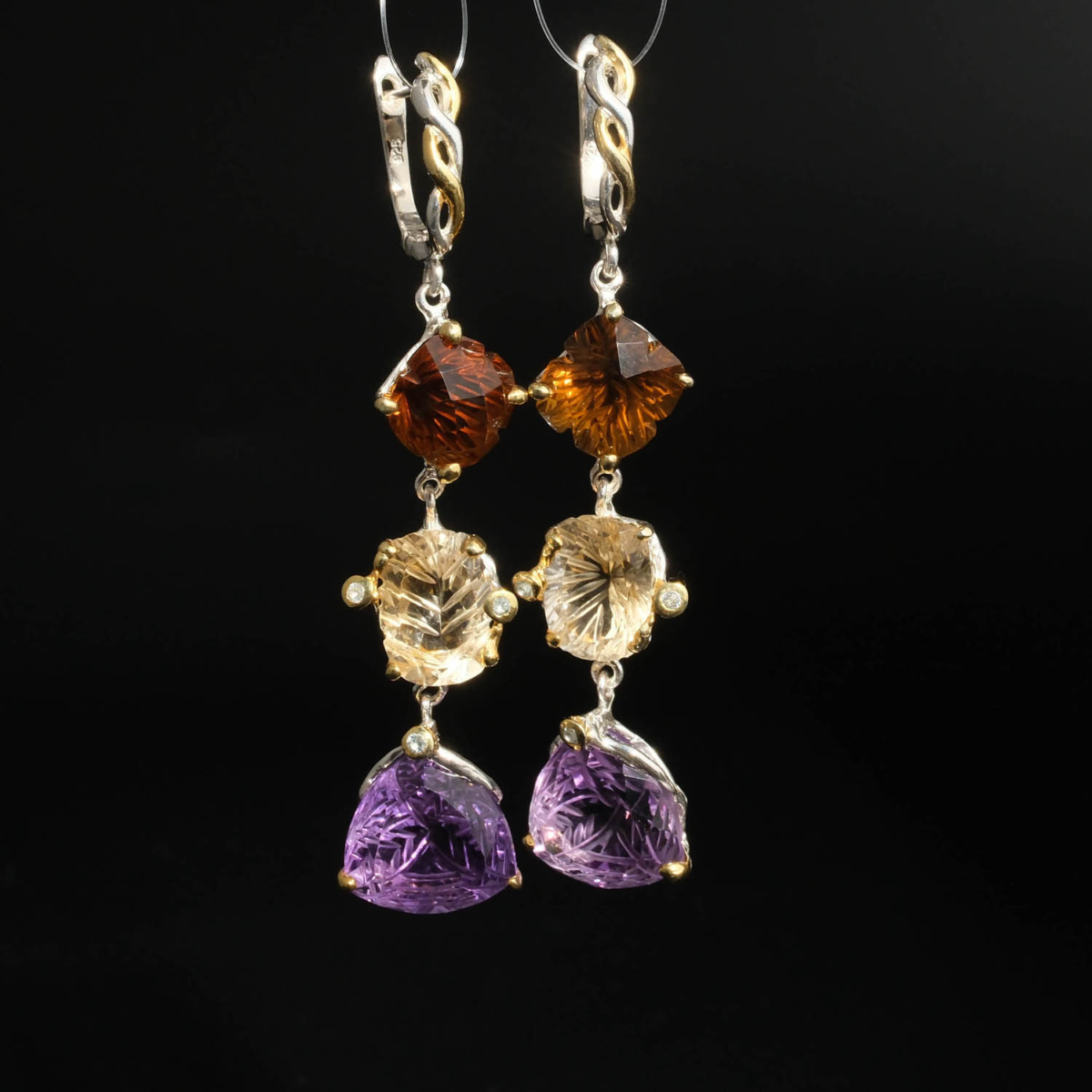 Natural multi-tone faceted purple amethyst and yellow citrine tiered dangle earrings in 925 silver on white silk.