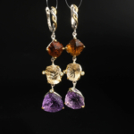 Natural multi-tone faceted purple amethyst and yellow citrine tiered dangle earrings in 925 silver on white silk.