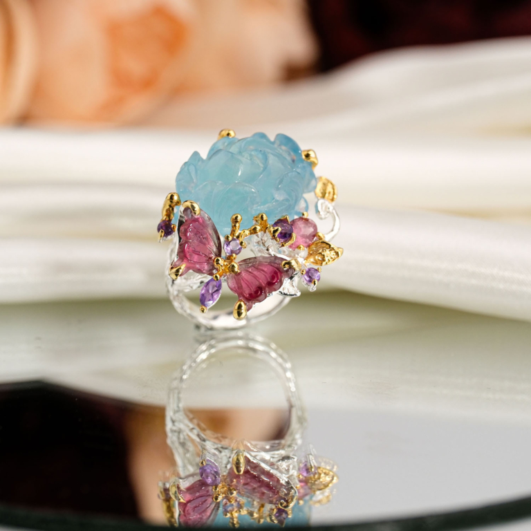 Hand carved natural aquamarine rose flower and pink tourmaline butterfly statement ring with amethyst accents 925 sterling silver white background.