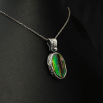 Genuine natural boulder opal gemstone oval cabochon 925 sterling silver artisan engraved pendant.