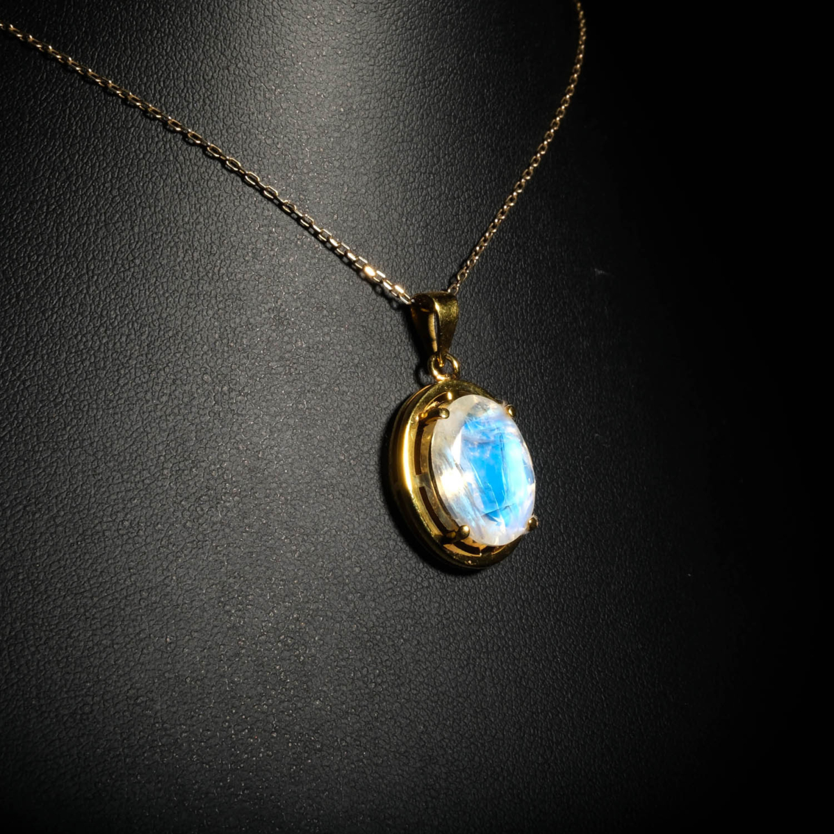 Genuine natural blue flash moonstone oval cabochon yellow gold plated 925 sterling silver pendant necklace.
