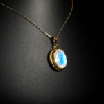 Genuine natural blue flash moonstone oval cabochon yellow gold plated 925 sterling silver pendant necklace.