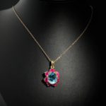 Natural faceted oval blue topaz pendant necklace with ruby flower halo in gold plated 925 silver on white satin.