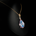 Genuine natural hand carved floral blue topaz pear gemstone pendant with amethyst halo 925 sterling silver black background.