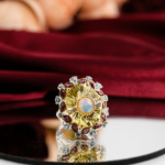 Natural radiant oval yellow citrine cocktail ring with center opal and rubellite tourmaline halo in 925 sterling silver on red velvet.