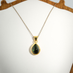 A gold-plated 925 sterling silver women's pendant featuring a natural pear-shaped cabochon dark green tourmaline gemstone in a bezel setting.