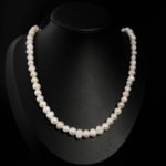 Natural 7-8mm freshwater pearl choker necklace with metal lobster clasp on emerald green satin