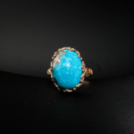 Natural high-dome oval cabochon Persian Neyshabur turquoise statement ring in rose gold plated 925 silver on white satin