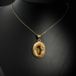 Natural faceted oval yellow citrine gemstone pendant necklace with textured border in gold plated 925 silver on white satin