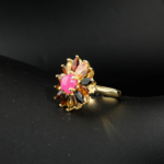 Natural cabochon pink ruby and marquise multicolor tourmaline flower statement ring in gold plated 925 silver on white silk.