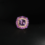 Genuine natural purple amethyst cushion cut double halo rose gold plated 925 sterling silver statement ring black background.
