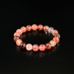 Genuine natural red hematoid fire quartz round bead stretch unisex statement bracelet 10-11mm black background.