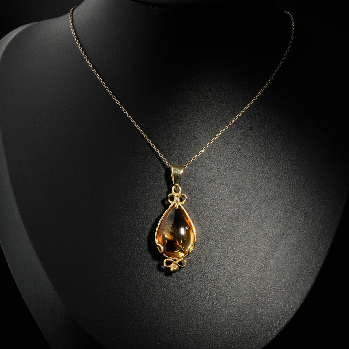 Natural faceted teardrop yellow citrine gemstone pendant necklace in 14k gold plated 925 silver on white satin.