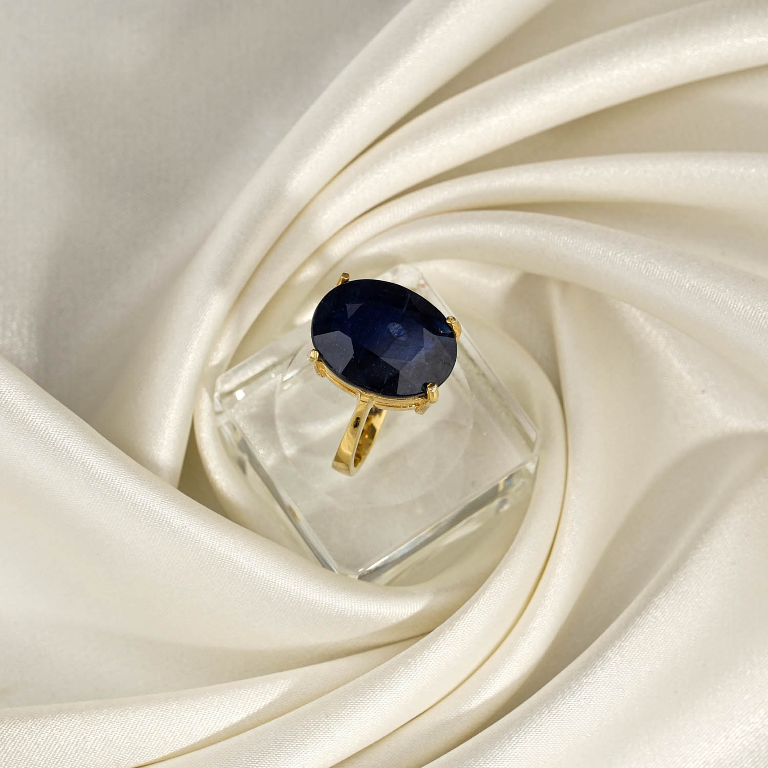 orijinal-safir-dogal-tas-oval-faset-925-ayar-gumus-gold-yuzuk Orijinal doğal derin lacivert fasetli oval safir taşı sarı altın kaplama 925 ayar gümüş tektaş kadın yüzük saten fon çekimi