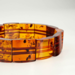Bracelet unisexe de luxe en ambre véritable certifié maillons style rolex nuances cognac.